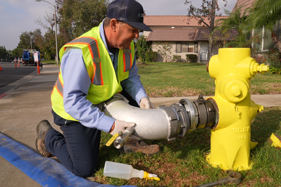 Man installing hose onto fire hydrant