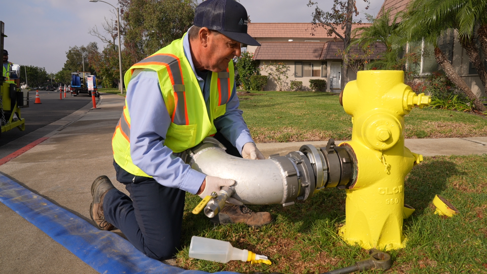 Man installing hose onto fire hydrant