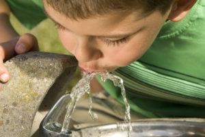 Kid drinking from water fountain